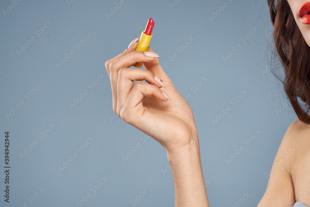 Woman with lipstick on a gray background brunette makeup with eye shadow on the eyelids Woman with lipstick on a gray background brunette makeup with eye shadow on the eyelids
