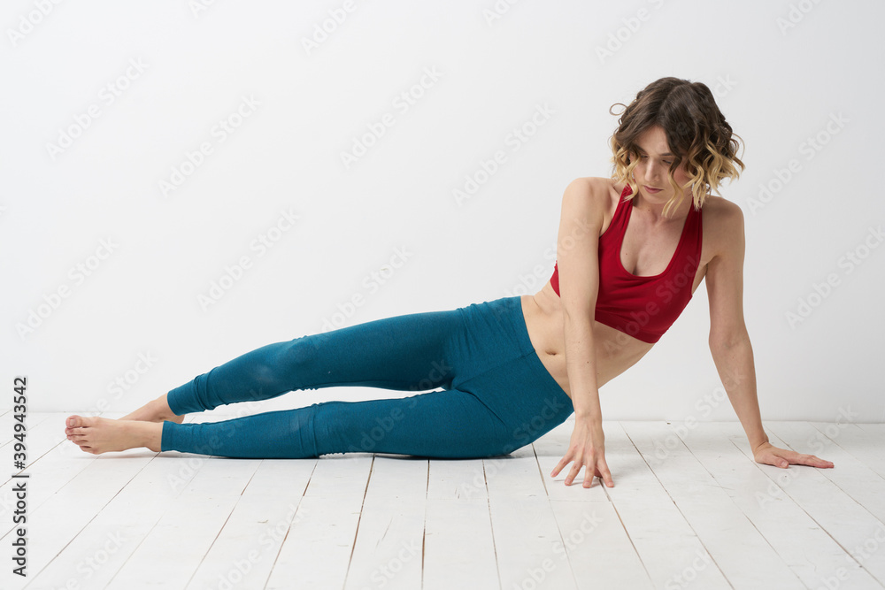 woman in leggings is engaged in gymnastics in a light room slim figure fitness sport