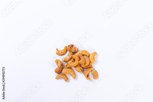 Cashew isolated on white background. Pile of Cashews nuts without shell closeup.