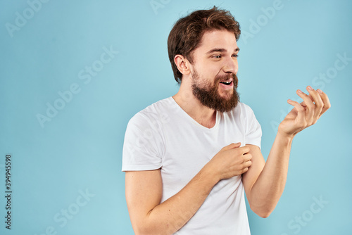 Cheerful man gesturing with his hands emotions cropped view on blue background studio