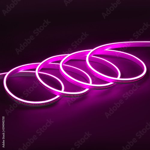 Purple glowing LED neon flex strip on black dark background