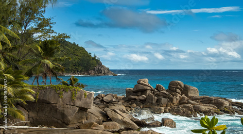 Lagoon with turquoise water, waves hitting the rocky shore, Seychelles.