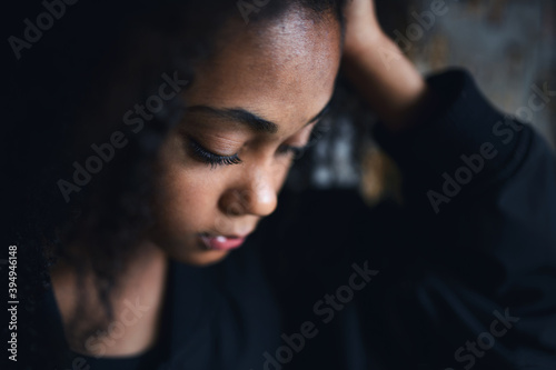Fototapeta Close-up portrait of sad mixed-race teenager girl standing, bullying concept