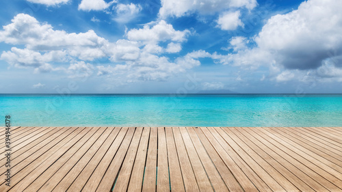 Tropical Sunny beach with wooden floor and the turquoise sea on Paradise island.