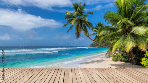 Fototapeta Naklejka Na Ścianę i Meble -  Paradise Sunny beach with wooden floor, palm trees and the turquoise sea on tropical island.