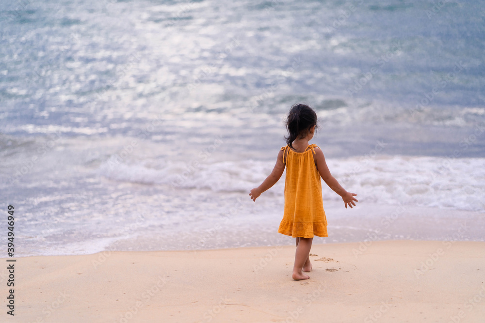 Active Young girl playing at the beach at Dusk. Active Young girl playing at the beach at Dusk.