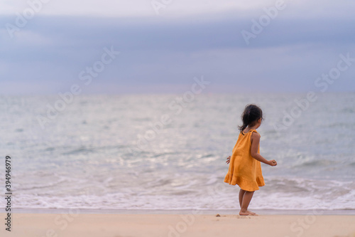 Active Young girl playing at the beach at Dusk.