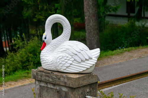 Fototapeta Naklejka Na Ścianę i Meble -  Swan statue at the entrance to fairies garden, Borsec, Romania