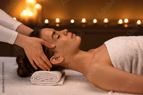 Young woman getting acupressure massage at modern luxury spa