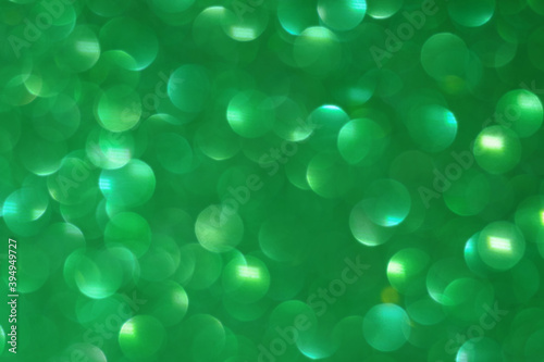 Green abstract lights background, bokeh shining, sparkling and glittering backdrop blurred image