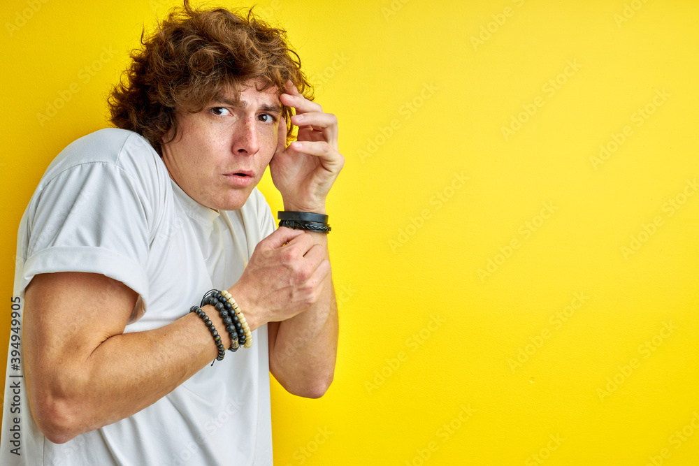 shocked emotional man is scared of something, look at camera shrinking isolated on yellow shocked emotional man is scared of something, look at camera shrinking isolated on yellow