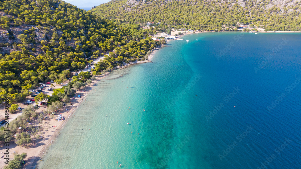 Fototapeta premium Peloponnese, Greece Aerial view on turqouise blue water and sandy beach. Limni Vouliagmeni or Ireon Lake, 
