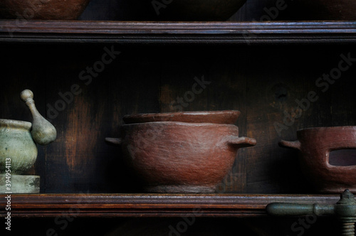 Old traditional Canarian pottery on a home shelf in Tenerife, Canary Islands, Spain, earthenware using local clay and natural dyes, semi-porous ceramic pots, jugs and plates used by native families