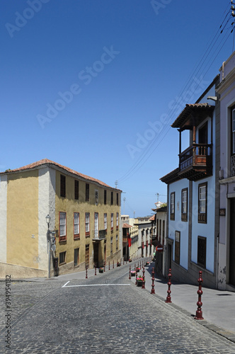 Quiet street with no people passing by on a sunny afternoon in La Orotava, beautiful charming traditional architecture with wooden balconies and old cobblestone road in Tenerife, Canary Islands, Spain