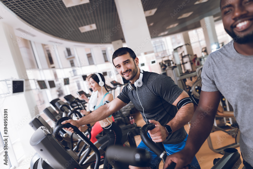 Cheerful athletes look at camera while training. Cheerful athletes look at camera while training.