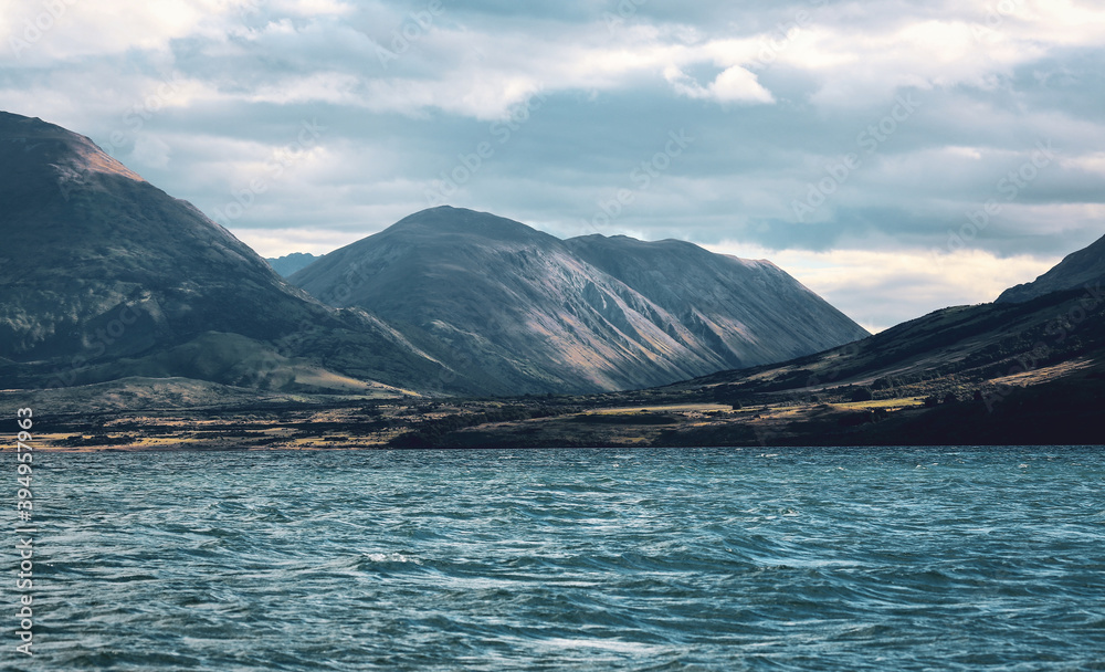 lake with small waves and mountains in New Zealand