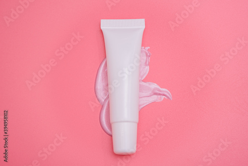 Lip gloss packaging on a pink background. Mockup