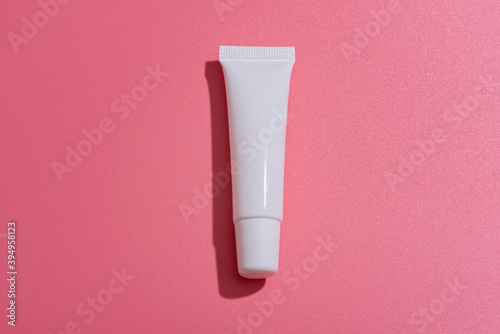 Lip gloss packaging on a pink background. Mockup