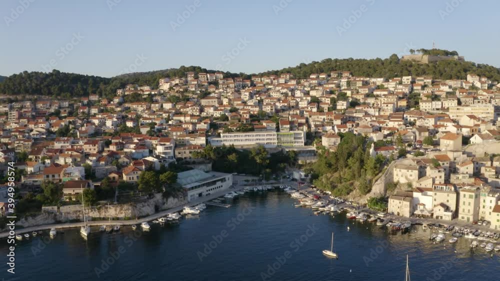 Aerial drone shot pulling slowly out and away from the perfect idyllic town and harbour of Sibenik, Croatia at sunset Aerial drone shot pulling slowly out and away from the perfect idyllic town and harbour of Sibenik, Croatia at sunset