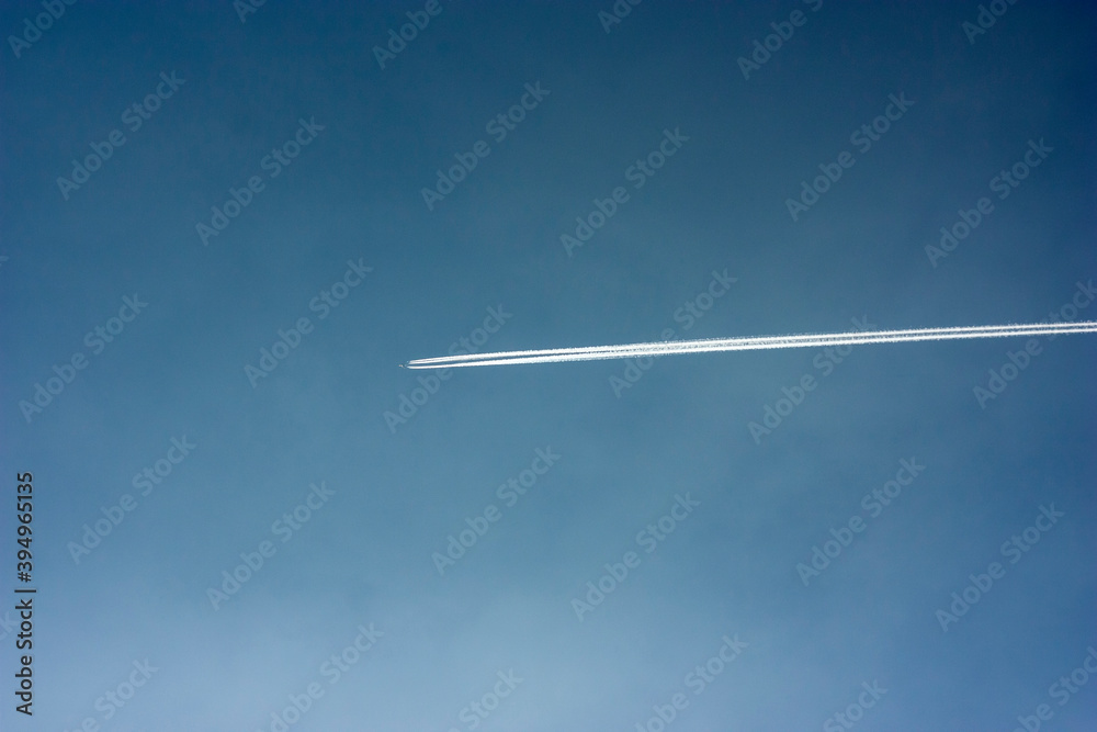 White trail from flying planes on the blue autumn sky. White trail from flying planes on the blue autumn sky.