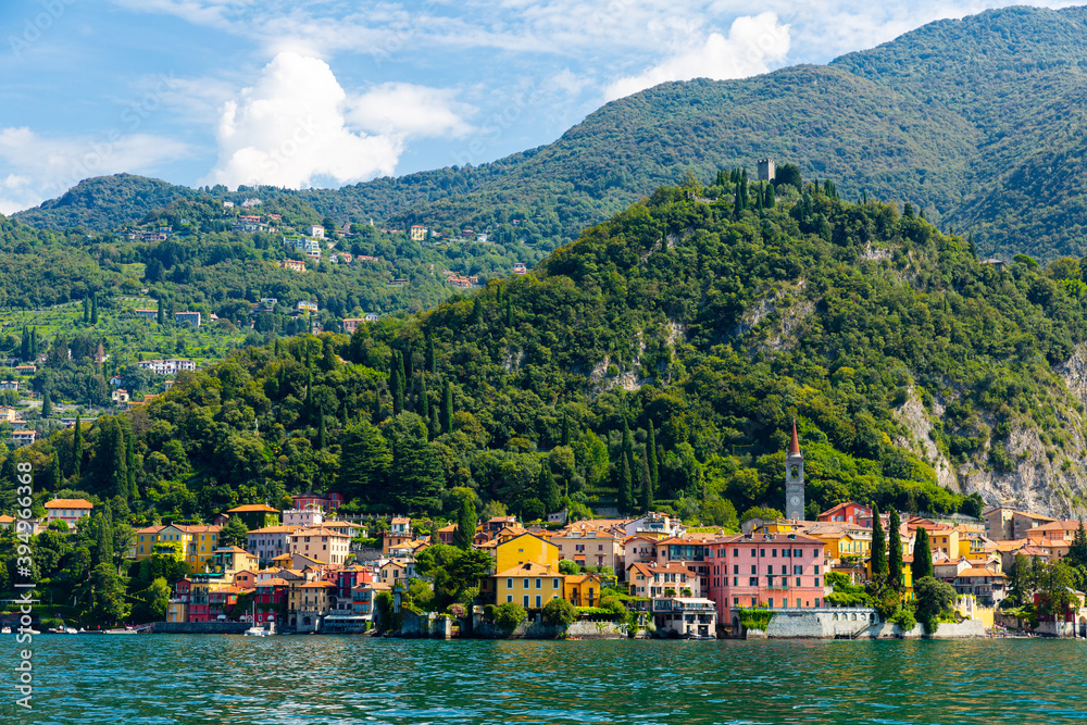 Spectacular view of Italian city of Varenna at foot of mountain on shore of Lake Como overlooking bell tower of Church of San Giorgio, Lombardy