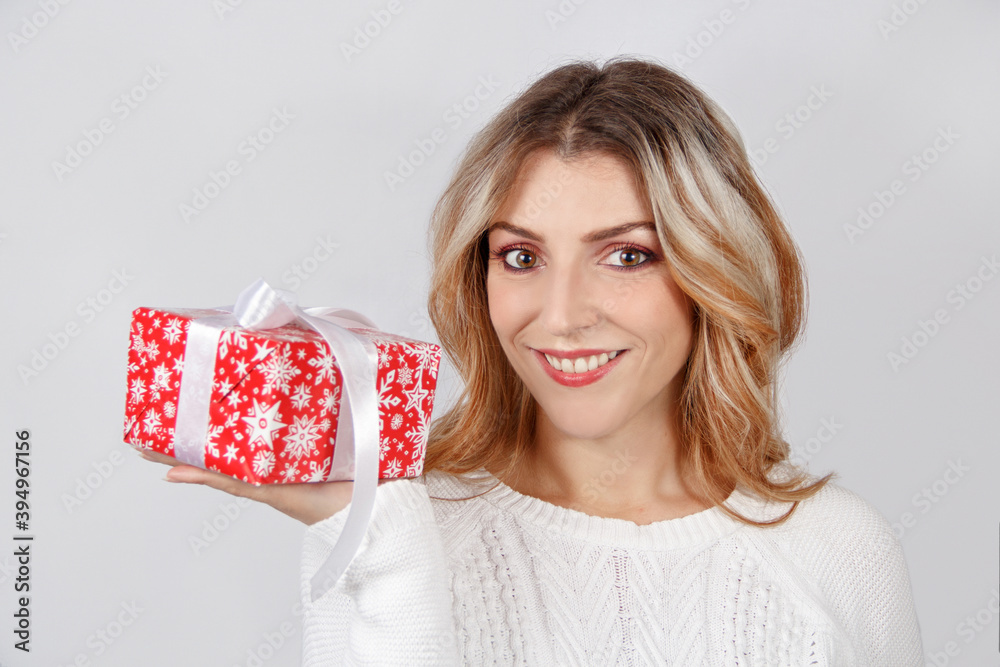Smiling young woman holding Gift in hand Smiling young woman holding Gift in hand