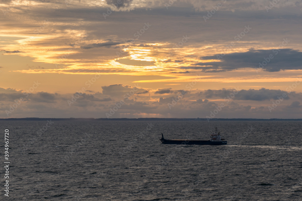 merchant ship in the north sea at sunset