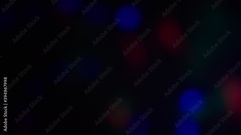 Abstract bokeh disco pink, green, blue color leaks, black background, lens flare