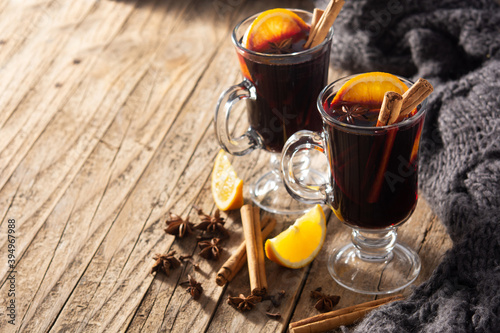 Traditional mulled wine with spices on rustic wooden table.Copy space