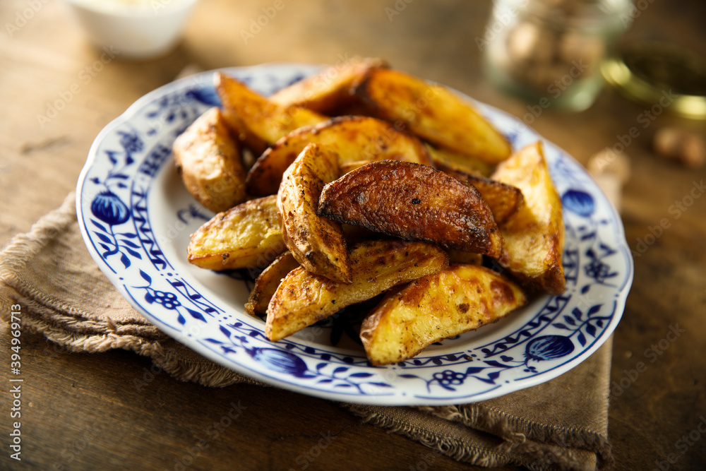 Homemade roasted potato wedges with spices Homemade roasted potato wedges with spices