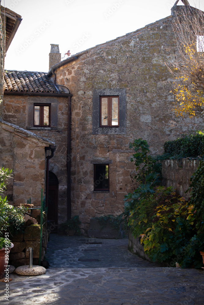 Fototapeta premium Civita di Bagnoregio is one of the most beautiful and characteristic Italian villages with corner of a quaint hill town, tiny alleys with the typical low-rise houses,typical of Medieval architecture.