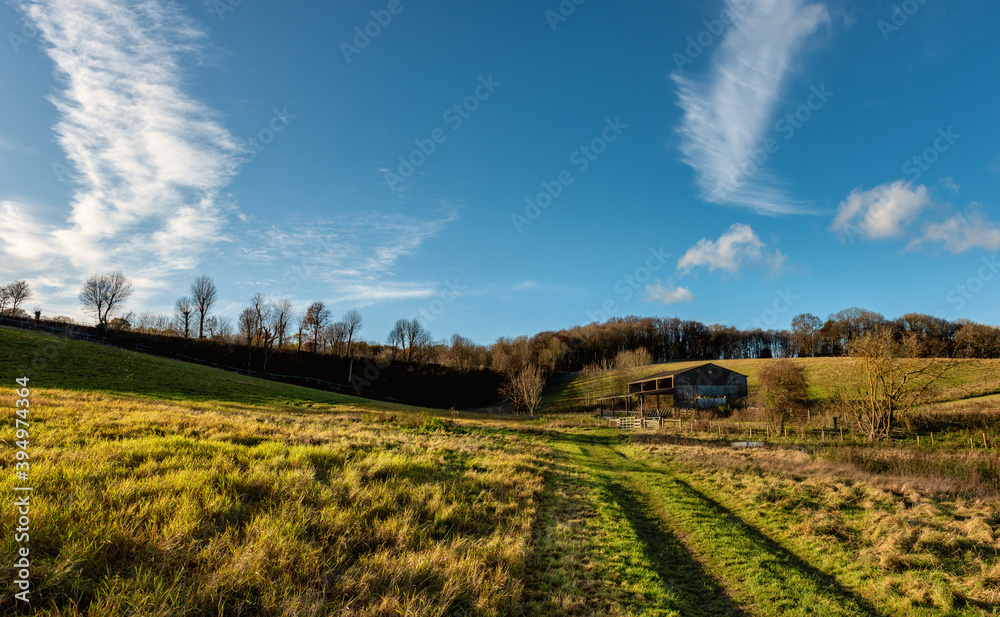 Walking path among fields by River Chess, Chiltern Hills, England Walking path among fields by River Chess, Chiltern Hills, England
