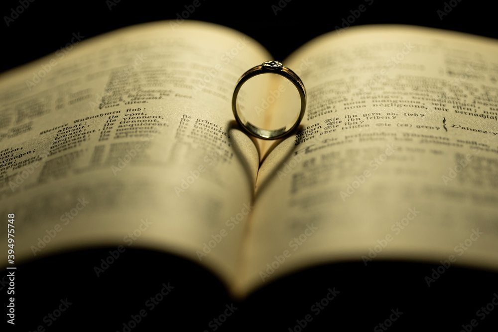 old book and heart shadow with an old saphire ring old book and heart shadow with an old saphire ring