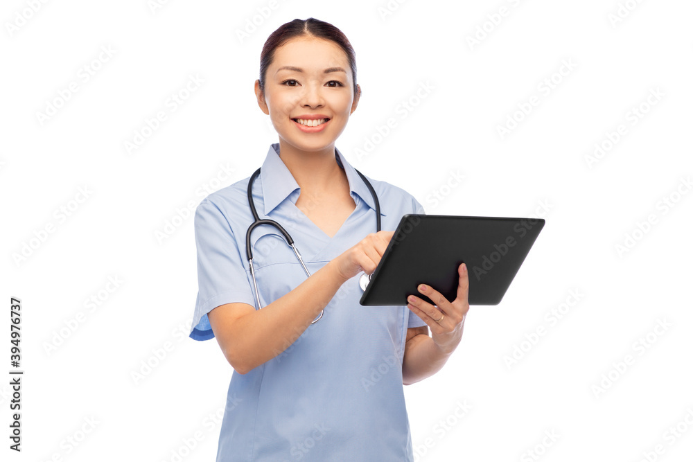 medicine, profession and healthcare concept - happy smiling asian female doctor or nurse in blue uniform with tablet pc computer and stethoscope over white background medicine, profession and healthcare concept - happy smiling asian female doctor or nurse in blue uniform with tablet pc computer and stethoscope over white background