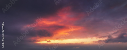 background of cloudscape at dusk with red clouds on sky © mimadeo