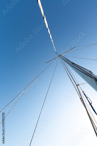 high metal yacht mast against the blue sky