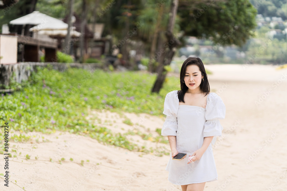 Beautiful woman walking on the beach in Phuket Thailand.