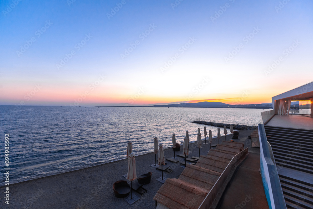 beautiful summer sunset on the shore of the sea bay