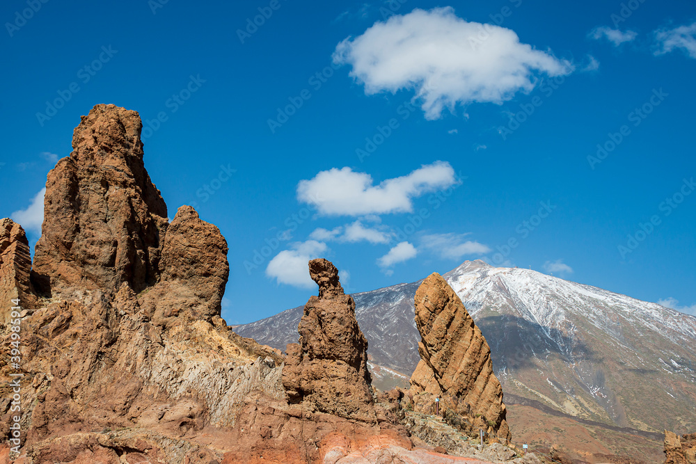 Mountains in Tenerife with the snow-capped Teide volcano in the background.