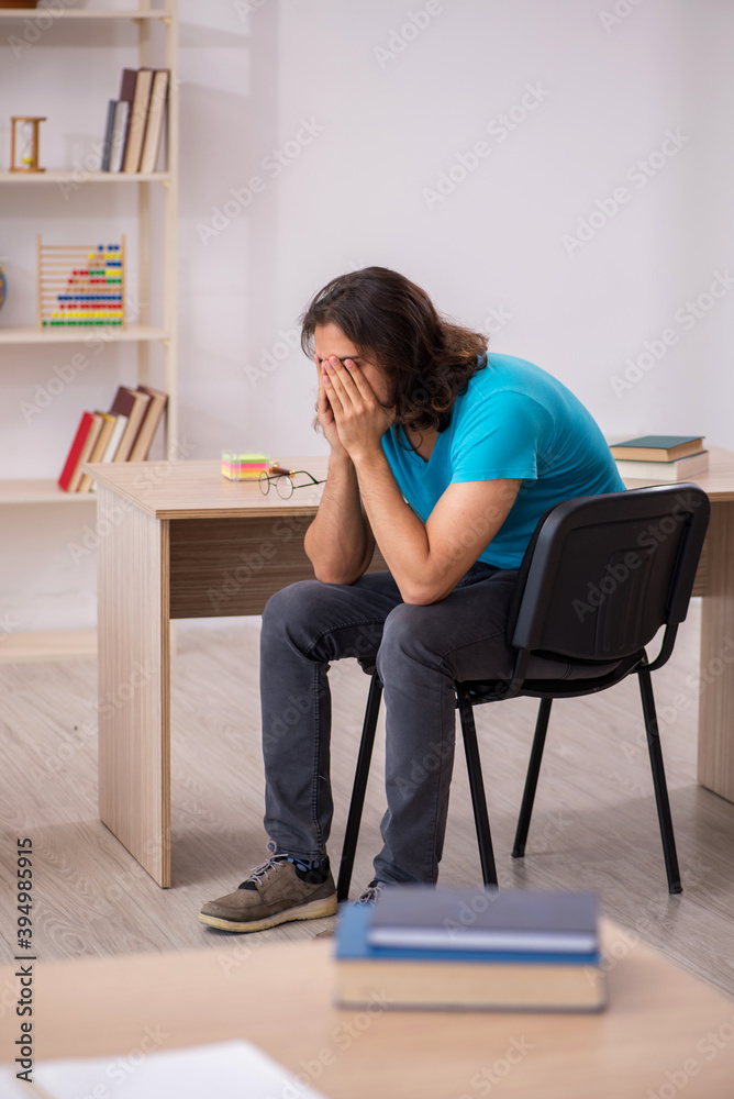 Young male student in front of green board Young male student in front of green board