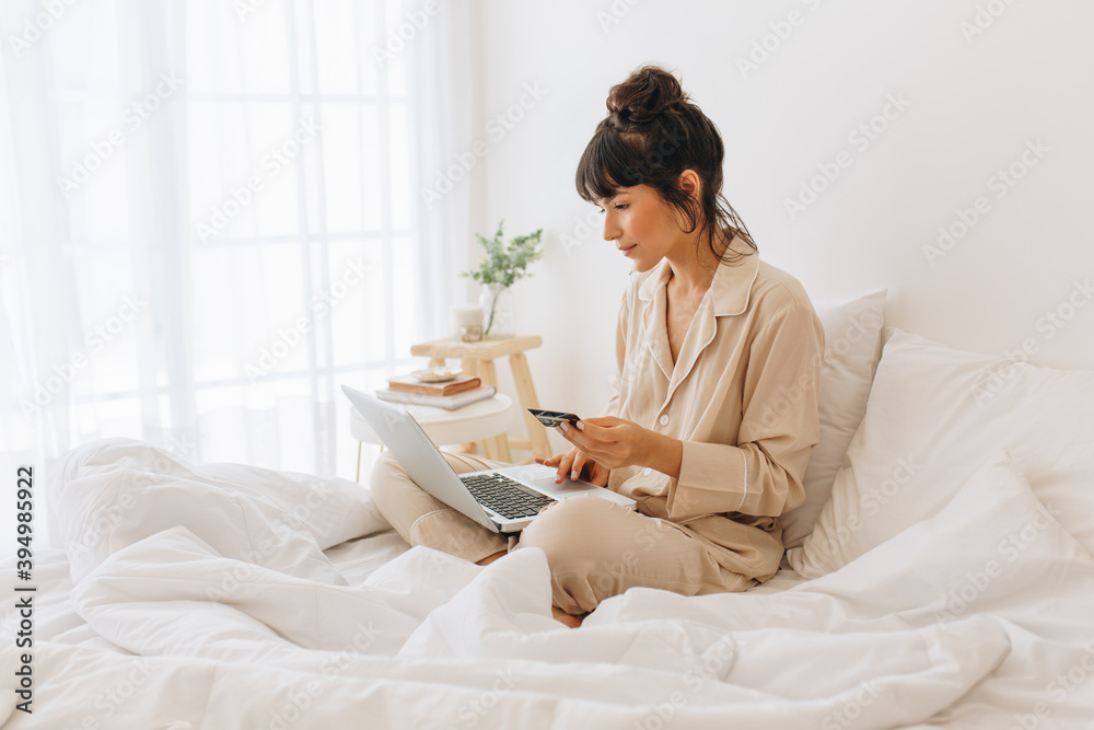 Woman doing online shopping on laptop computer Woman doing online shopping on laptop computer