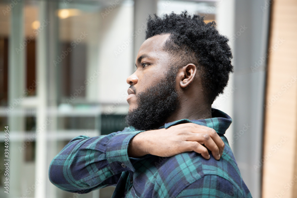 Man scratching suffering from itching shoulder skin; sick African man scratching his skin with allergy, rash, ringworm, tinea problem; skin care, dermatology concept; adult black African man model Man scratching suffering from itching shoulder skin; sick African man scratching his skin with allergy, rash, ringworm, tinea problem; skin care, dermatology concept; adult black African man model