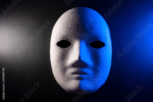Mask on black background, mysterious concept