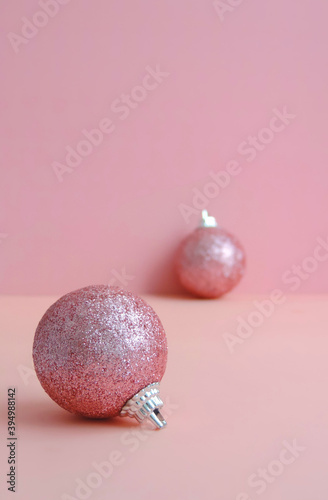 Social distancing sign. Abstract pink background with christmas toys balls. Prevention COVID-19, coronavirus and healthcare concept.  Holidays social distance concept , minimal