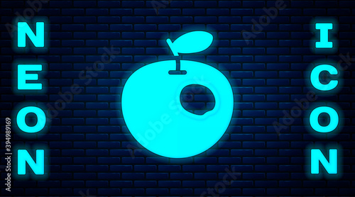Glowing neon Genetically modified apple icon isolated on brick wall background. GMO fruit. Vector.