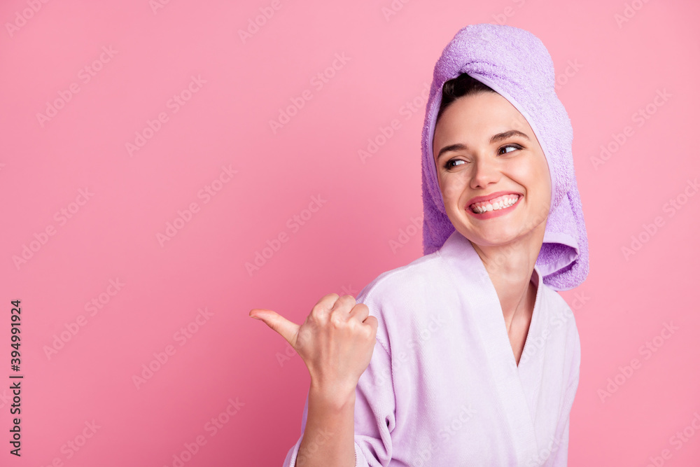 Close-up portrait of attractive cheerful girl wearing turban on head demonstrating copy space offer isolated over pink pastel color background - obrazy, fototapety, plakaty 