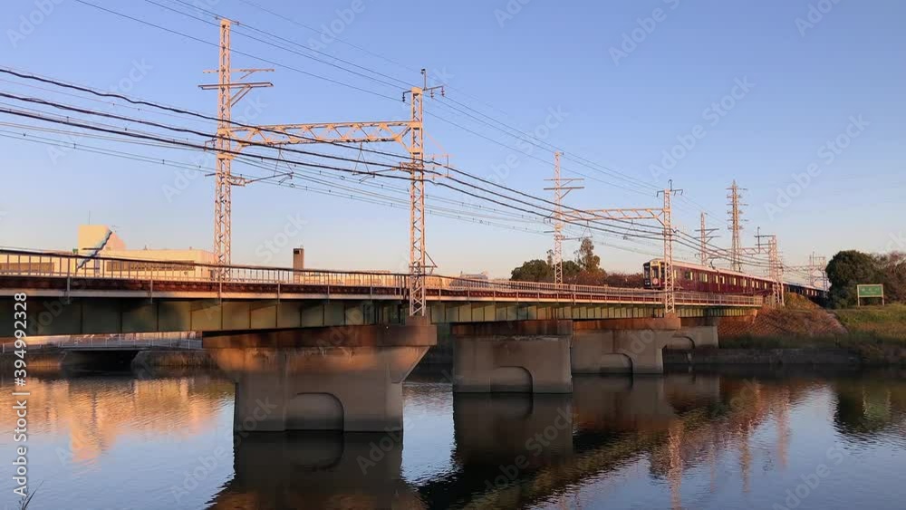 Hankyu train crossing a bridge over a river in Osaka, Japan. Hankyu train crossing a bridge over a river in Osaka, Japan.