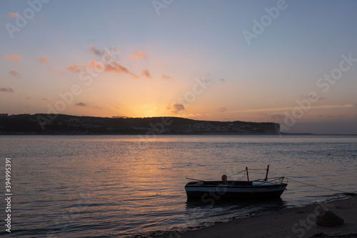 Fishing boats on a river sea at sunset in Foz do Arelho, Portugal © Luis