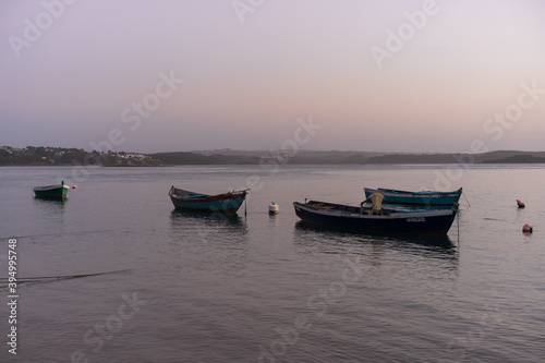 Fishing boats on a river sea at sunset in Foz do Arelho, Portugal