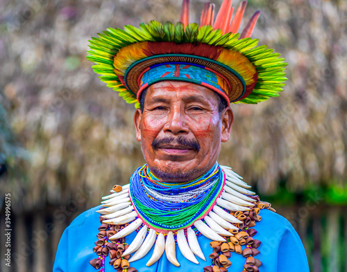 Ecuador. A Shaman from the Siona Community in his traditional costume stands model for a photo. Taken in the Amazonian territory near Puerto Bolivia on the Cuyabeno river photo